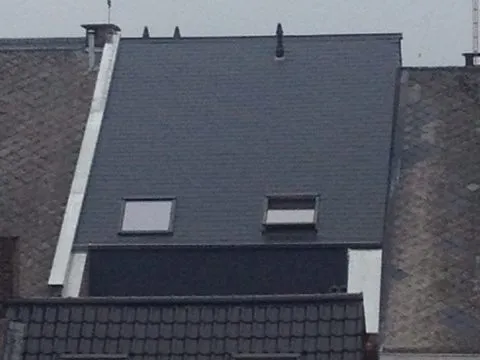 Vernieuwd hellend dak met twee dakvlakramen tussen twee bestaande woningen